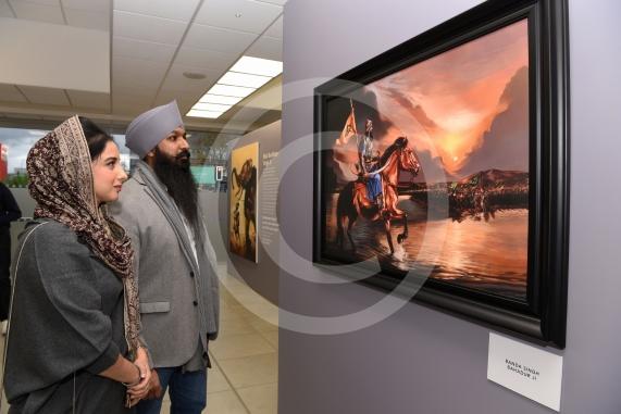 LtoR Jagdeep Kaur and Amritpal Singh look at paintings by artist Kanwar Singh. A Sikh art exhibition which brings together the work of renowned Canadian artist Kanwar Singh and art from young volunteers from Slough is launching at the Guru Maneyo Granth Gurdwara.Guru Maneyo Granth Gurdwara, Bath Rd, Slough