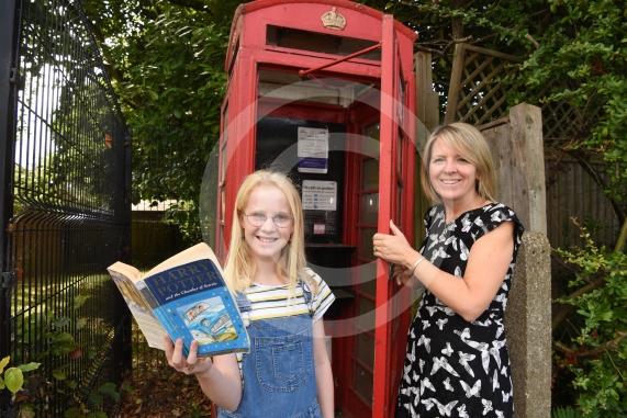 LtoR Tate Pickering, 11 and Kirsty Clark from The Friends of Holyport College.Tate Pickering who had the idea of transforming an unused red phone box into a book swap library.Stroud Farm Road, Holyport, Maidenhead. 