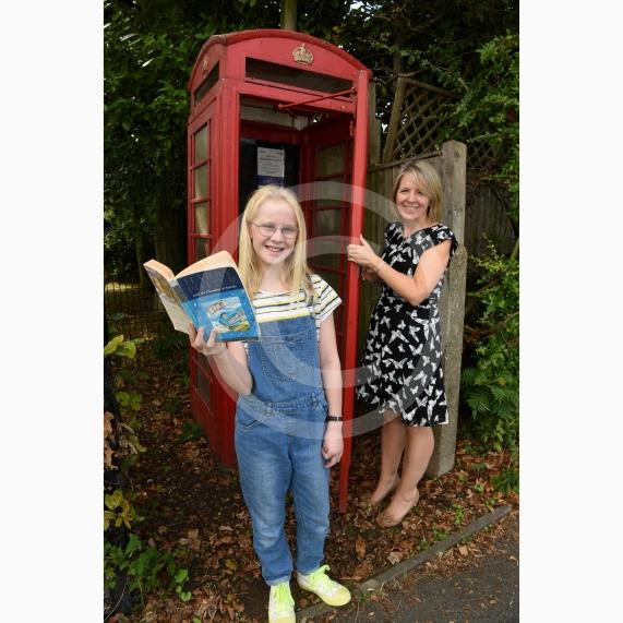 LtoR Tate Pickering, 11 and Kirsty Clark from The Friends of Holyport College.Tate Pickering who had the idea of transforming an unused red phone box into a book swap library.Stroud Farm Road, Holyport, Maidenhead. 