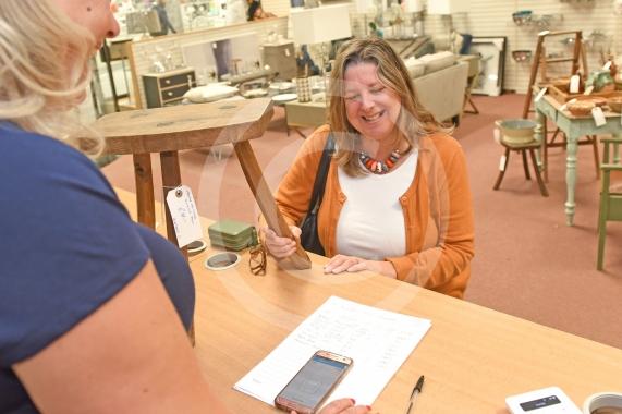 A shopper purchases a wooden stool, Pop Up Maidenhead store opens opposite Tesco inside Nicholson Shopping Centre - Photo: Emma Sheppard 4/9/18