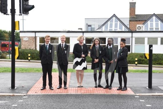 Headteacher, Frances Walsh, and some children by the traffic light crossing outside the school. The school have had an application to install double yellow lines approved.Cox Green School, Highfield Lane, Maidenhead 
