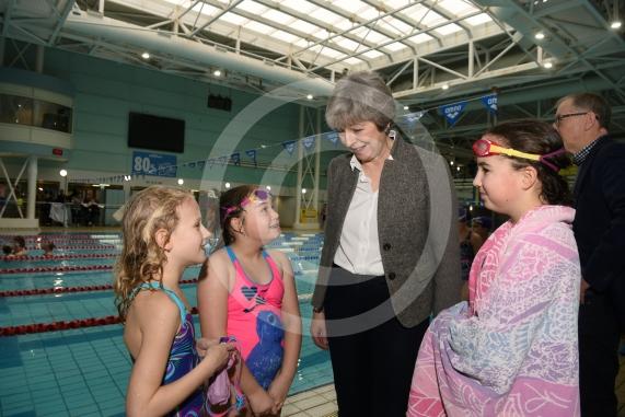 The Prime Minister Theresa May meets swimmers LtoR Scarlett Smith, eight, Charlotte Sloan, nine and Tasha Sloan, 12.The Prime Minister Theresa May and Philip May visit the 34th Maidenhead Swimarathon at the  Magnet Leisure Centre, Holmanleaze, Maidenhead. 