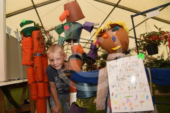 Simeon Crooks, six, looks at the scarecrows made by local primary schools.Annual Stoke Poges Horticultural showStoke Poges school, Rogers Lane, Stoke Poges.