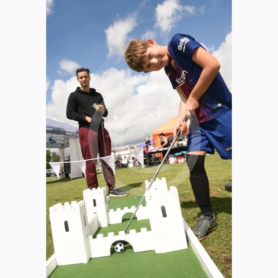 LtoR Danny Djakovic and George Djakovic, eight, play pop up mini golf.Twyford Village fete, Stanlake Meadow recreation ground, Waltham Road, Twyford.