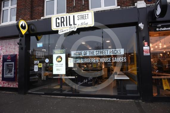 Grill Street owner Bilal Malik , has put up electronic awareness raising signs for COVID-19. Grill Street, 232 Farnham Rd, Slough 