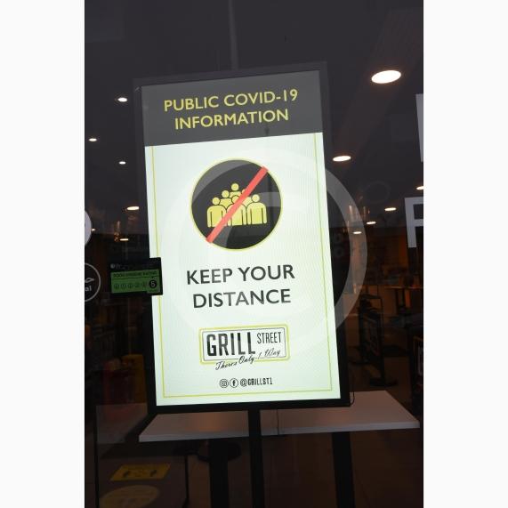 Grill Street owner Bilal Malik , has put up electronic awareness raising signs for COVID-19. Grill Street, 232 Farnham Rd, Slough 