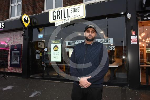 Grill Street owner Bilal Malik , has put up electronic awareness raising signs for COVID-19. Grill Street, 232 Farnham Rd, Slough 