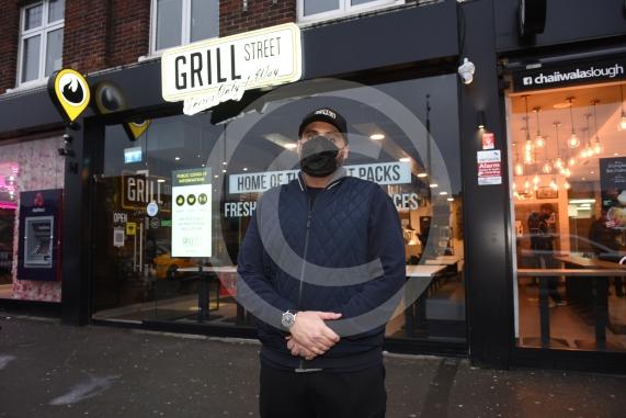 Grill Street owner Bilal Malik , has put up electronic awareness raising signs for COVID-19. Grill Street, 232 Farnham Rd, Slough 