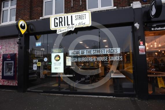 Grill Street owner Bilal Malik , has put up electronic awareness raising signs for COVID-19. Grill Street, 232 Farnham Rd, Slough 
