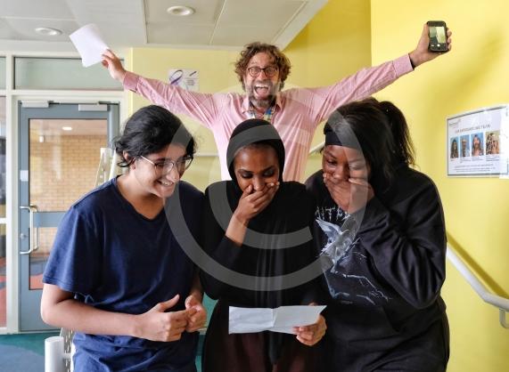 A Level Results Day 18/8/22 Pics: Mike Swift - Beechwood School - Garv Prashar, Maryan Ali and Rachel Annan check results to the delight of Teacher Iain Priestley.