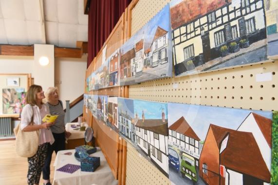 Visitors looking at paintings, LtoR Barbara Kosinski and Margaret Cathie.Cookham Arts Club summer exhibition. Pinder Hall, 2 Lower Road, Cookham