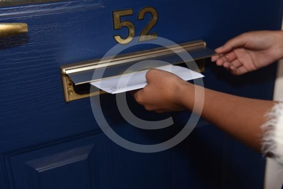Posed shot of letter posting