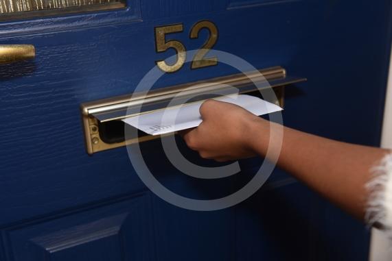 Posed shot of letter posting