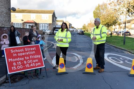High Street Langley, LangleyHoly Family Catholic School Headteacher Sara Benn and Site Manager Edward Thercaj operating the moveable barriers as part of the School Street scheme. 