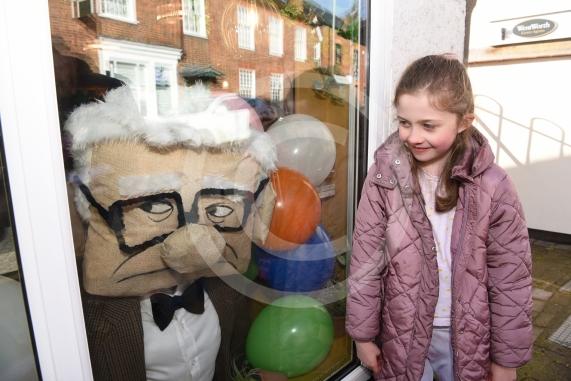 Chloe Russell, eight, looks at the scarecrow based on a character from the film Up.Twyford Scarecrow Trail 2023, Twyford.
