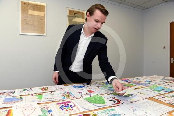 In the officeMP Josh Reynolds picking out his Christmas card winners