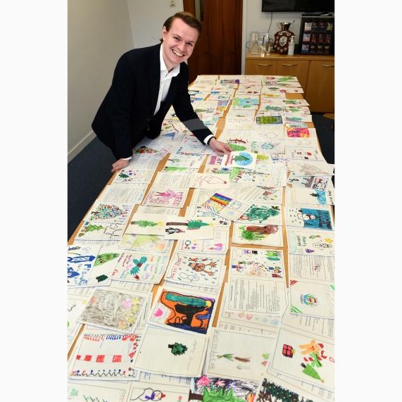 In the officeMP Josh Reynolds picking out his Christmas card winners