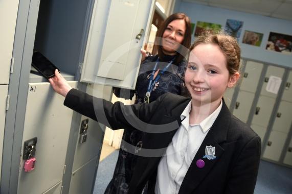 Headteacher Jo Capon and students outside Newlands Girls' School, Maidenhead The school is implementing a ban of smartphones on the school site from September. 