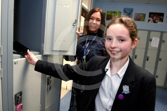 Headteacher Jo Capon and students outside Newlands Girls' School, Maidenhead The school is implementing a ban of smartphones on the school site from September. 