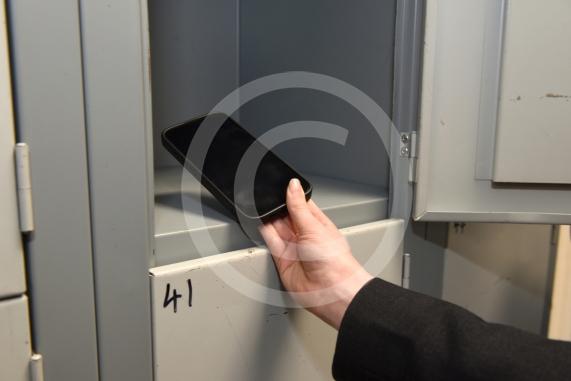 Headteacher Jo Capon and students outside Newlands Girls' School, Maidenhead The school is implementing a ban of smartphones on the school site from September. 