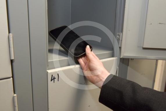 Headteacher Jo Capon and students outside Newlands Girls' School, Maidenhead The school is implementing a ban of smartphones on the school site from September. 