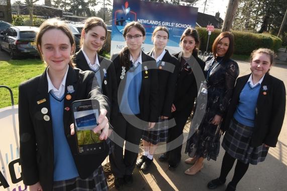 Headteacher Jo Capon and students outside Newlands Girls' School, Maidenhead The school is implementing a ban of smartphones on the school site from September. 