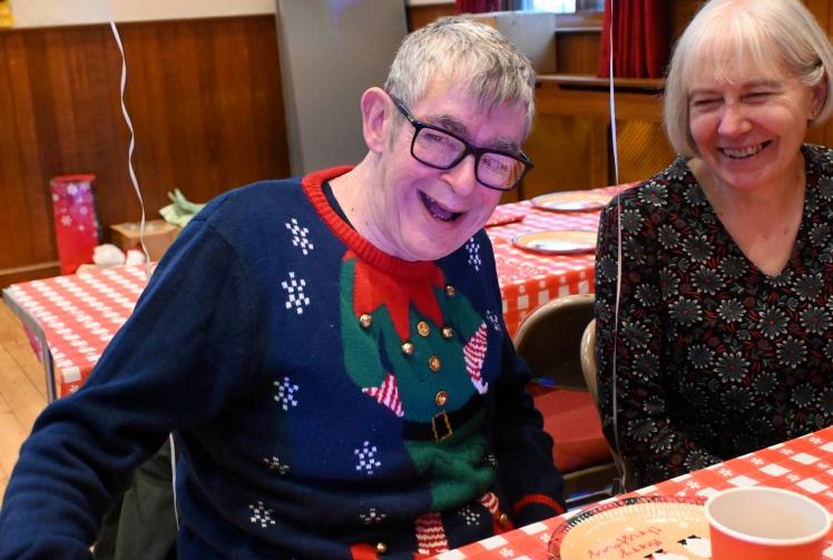 Mencap members receive presents at Christmas party